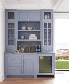 a kitchen with blue cabinets and white walls