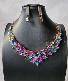 Ravishing Multicolored Rhinestone  Statement Necklace Set.  Beautiful hints of green, purple and blue that makes this necklace set eye-catching. Vibrant and stunning piece for many occasions.  *SHIPPING It will take about 2-5 business days to process your GEMS. I DONT SHIP on WEEKENDS or HOLIDAYS. Once your item has shipped you will receive an email through Etsy. Delays due to weather or package arriving later than expected can happen so please be patient and understanding. Make sure to call your local post office to find out the wear abouts of your package.  *RETURNS ** ALL JEWELRY ARE FINAL SALE!! RETURNS AND EXCHANGES ARE NOT ACCEPTED If there is an issue with your GEMS due to the handling of shipping please contact me. Thank you for shopping at mt store. Elegant Multicolor Crystal Necklaces For Party, Multicolor Crystal Jewelry Sets For Parties, Purple Jewelry With Sparkling Stones For Party, Elegant Multicolor Rhinestone Necklace For Gift, Elegant Multicolor Jeweled Crystal Necklaces, Multicolor Rhinestone Necklace With Sparkling Stones For Party, Green Rhinestone Jewelry Sets For Party, Elegant Multicolor Rhinestone Necklace For Party, Multicolor Rhinestone Necklace For Party