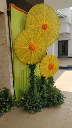 two yellow umbrellas sitting in front of a building