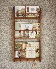 a wooden shelf filled with books on top of a wall