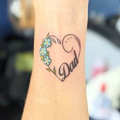 a small tattoo on the wrist of a woman with an elephant and flowers in it