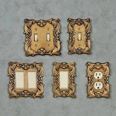 four light switch plates with ornate designs on each one and two toggles in the middle