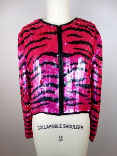 "This is a breathtaking piece of glam! It's all hand embellished with neon pink sequins in a wild striped tiger design and accented with black glass beading along the edges. It's in perfect condition! Bust - 40\" Shoulders - 16\" Sleeves - 23\" Top to Bottom - 17\" Tag Size - Large All of my items come from a smoke-free and pet-free home. If you have any questions, please don't hesitate to ask!" Wild Tiger, Tiger Design, Sequin Jacket, Vintage Glam, Tiger Stripes, Pink Sequin, Tiger Print, Cropped Jacket, Crop Jacket