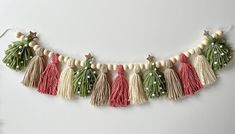 the tassels are hanging from the string on the wall, with beads and bead