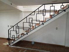 an empty room with a stair case and tile flooring on the ground next to it