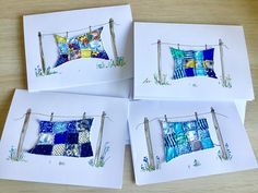 four cards with quilts hanging on clothes pins