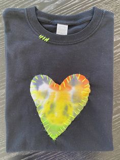 a t - shirt with a heart painted on it