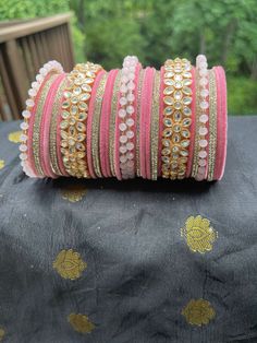 Pink and Golden Pearl & Kundan Bangles - Flaunt your style with this beautiful pair of pink and golden bangles. Crafted with intricate detailing of pearl and kundan stones, these bangles are made of copper and are 2.8 inches in size. Perfect for any traditional occasion, these bangles are a must-have addition to any wardrobe. Features:  * Crafted with intricate detailing of pearl and kundan stones * Made of copper * 2.8 inches in size * Perfect for any traditional occasion Traditional Pink Bangle For Party, Bangle Set Pink, Pink Bangles Set, Pink Bangles Set Indian, Cheap Traditional Pink Bangle, Traditional Pink Bangle, Pink Kundan Bangle For Gift, Stylish Bangles, Indian Bracelets