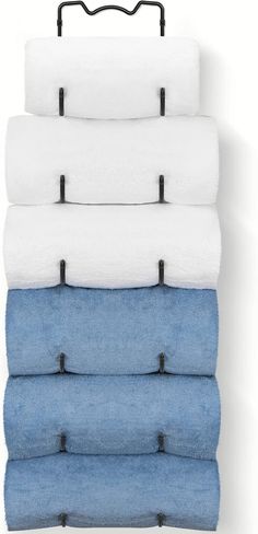 four towels hanging on a towel rack in different colors and sizes with black metal handles