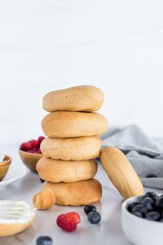 a stack of doughnuts sitting next to berries and yogurt