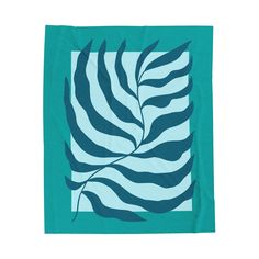 a teal and white towel with a leaf on the front, against a white background