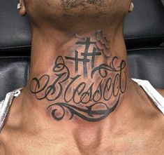 a man with a cross and the word jesus tattooed on his neck