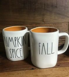 two coffee mugs that say pumpkin spice, fall and pumpkin pie on the side