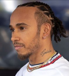 a close up of a person with dreadlocks wearing a white t - shirt