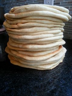 a stack of pita bread sitting on top of a counter