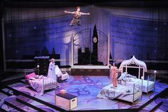 an image of a stage setting with people on the bed and in the middle of it