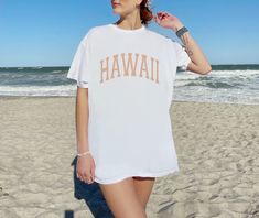 The perfect beachy, retro Hawaii shirt! This tshirt is super comfy and soft, and has a very cool aesthetic style. This shirt is true to size. For an oversized look size up 2/3 sizes from your normal size. Please check the product dimensions in the photo section, to confirm the right size for you. CUSTOMIZATION: If you would like this design in another color or on another medium such as a sweatshirt, hat, socks, bag, poster, wall decal, poster etc. Please feel free to reach out to me and let me k Oversized Beachy T-shirt For Vacation, Casual White T-shirt For Vacation, Oversized Summer Tops For Leisure, White Hawaiian Top For Beach Season, Casual Beach Season Tops, Casual Beach Tops For Leisure, Casual Beach Season Tops For Leisure, Oversized White T-shirt For Vacation, Casual Tops For Beach Season Leisure