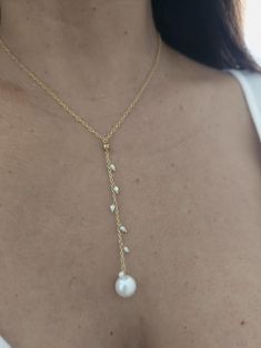 Gold filled Fresh water Pearl Lariat necklace.  18" with and additional  3" drop in the front. **Pearls are exquisite gems produced by a living oyster, and they are a truly wonder of nature.  Each pearl is one-of-a-kind creation, with its own shape, size, color, and blemish.  From salt water pearls to fresh water pearls, from South Sea pearls to Tahitian pearls. Either flawless or baroque, beauty is in the eye of the beholderThe pearl in the picture is the pearl that you will receive. Pearl Lariat Necklace, Pearl Lariat, Pearl Drop Necklace, Fresh Water Pearl, Water Pearls, Sea Pearls, South Sea Pearls, Tahitian Pearls, Drop In