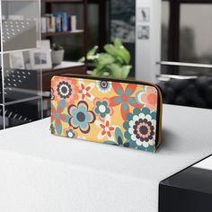 Designed with love and adorned with a groovy 60's and 70's mcm boho floral design, our zipper wallet is made from cruelty-free faux leather, so you can flaunt your unique style without compromising your values! Inside the zipper closure, you'll find pockets designed to hold your cash, credit cards, coins, and checkbook, ensuring your valuables are secure while you are free to go where your carefree spirit takes you! *Note that this item prints and ships from our overseas production partner in Ch Retro Wallets With Interior Card Slots, Vintage Multicolor Wallets For Everyday Use, Vintage Multicolor Wallet For Everyday Use, Vintage Multicolor Wallet For Daily Use, Retro Style Rectangular Wallets For Daily Use, Retro Rectangular Wallets For Daily Use, Retro Wallets With Interior Card Slots For Daily Use, Vintage Wallets With Zipper Closure For Daily Use, Vintage Multicolor Travel Wallets