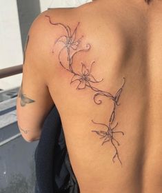 the back of a woman's shoulder with flowers on it