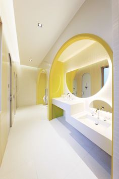 a bathroom with two sinks and a mirror in the middle of it's walls