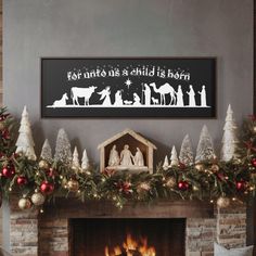 a fireplace decorated with christmas decorations and garlands in front of a lit mantel