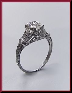 a diamond engagement ring with an intricate design