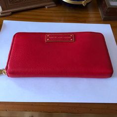 100% Cow Leather, Imported, Polyester Lining, Four Card Slots, One Slip Pocket. Brand New With Tags. This Is A Vibrant And Rich Red Wallet! So Soft And Beautiful That It Can Also Be Used As A Clutch, If You Want To Show It Off! It Can Hold Everything You Would Want To Put In A Wallet Even A Phone. It Features The Logo Plaque At Front, Polished Brass Tone Hardware. Lined With Red Logo-Jacquard Fabric; Three-Compartment Gusseted Interior Features Two Bill Pockets, Twelve Card Slots, One Slip Pocke Designer Red Wallet For Travel, Designer Red Wallet For Daily Use, Red Designer Wallets For Daily Use, Bags Marc Jacobs, Too Hot To Handle, Red Wallet, Marc Jacobs Bag, Red Logo, Jacquard Fabric