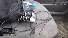 an assortment of headphones and earbuds in the back seat of a car