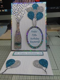 a birthday card with blue and silver decorations