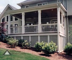 a large gray house with white balconies