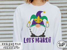 a woman wearing a white sweatshirt with the words let's mardi on it