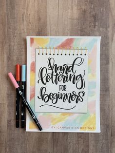 a notebook with the words hand lettering for beginners written on it next to markers