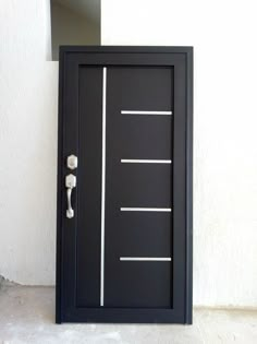 a black door with white lines painted on the front and side by side, next to a wall