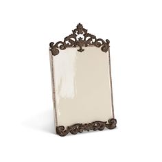 an ornately decorated mirror is shown against a white background