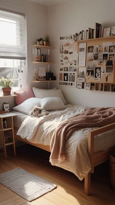 a bed sitting in a bedroom under a window next to a wooden table and chair