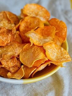 a bowl filled with potato chips on top of a table