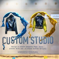 a display case with clothes on it and the words custom studio