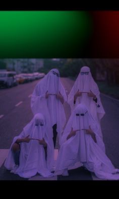 three women dressed in white walking down the street