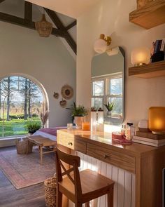 a living room filled with furniture and a large window covered in natural light next to a wooden table