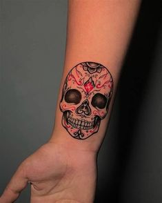 a hand with a skull tattoo on it