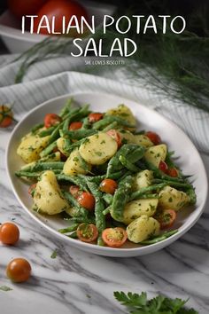 a white bowl filled with green beans and tomatoes on top of a marble countertop