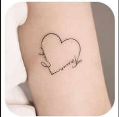 a heart shaped tattoo with the word love written in cursive writing on it