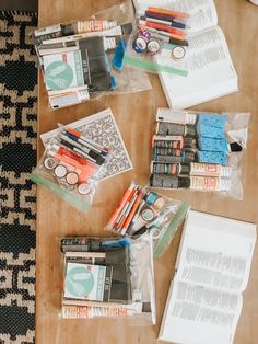 the contents of a craft kit laid out on top of a wooden table with scissors, markers and pens