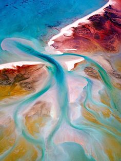 an aerial view of the ocean and land from space, with blue water in it