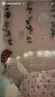 a bedroom with pink walls and flowers on the wall