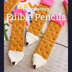 two crackers with marshmallows on them and the words, introduced edible pencils