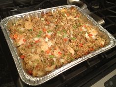 a pan filled with rice and vegetables on top of an oven