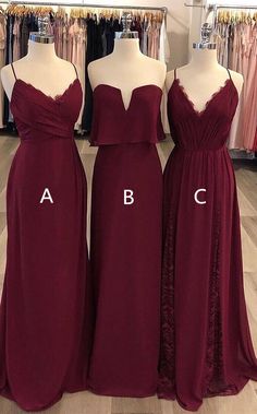 three bridesmaid dresses on mannequins in a store