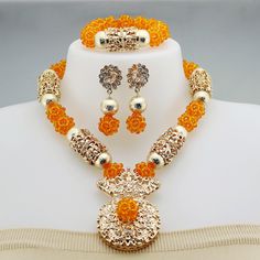 a necklace and earring set with orange beads